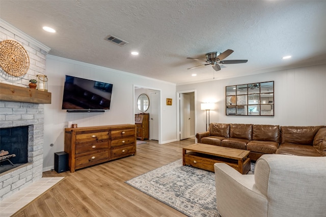 2827 Fontana Dr, Houston, TX 77043 - living room with ornamental molding, ceiling fan, light wood-type flooring, a brick fireplace, and a textured ceiling