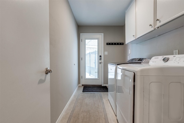 2827 Fontana Dr, Houston, TX 77043 - laundry area with cabinet space and washing machine and clothes dryer