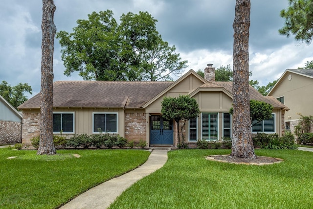 2827 Fontana Dr, Houston, TX 77043 - view of front of home with a chimney, a front lawn, roof with shingles, and brick siding