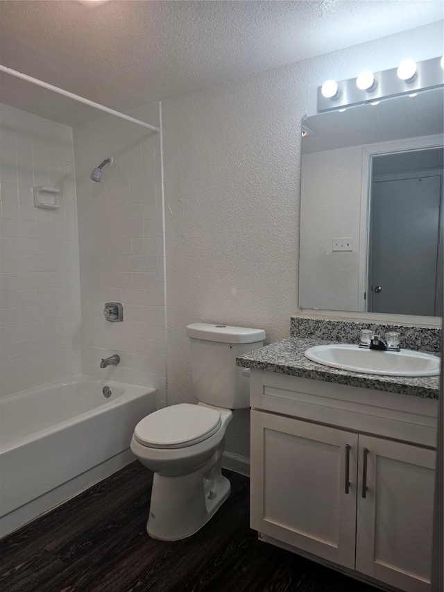 9201 Clarewood Dr Unit 204, Houston, TX 77036 - full bathroom featuring wood finished floors, a textured wall, vanity, shower / tub combination, and a textured ceiling