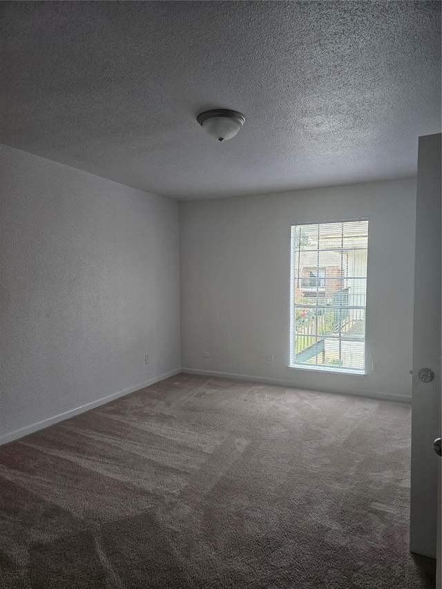9201 Clarewood Dr Unit 204, Houston, TX 77036 - carpeted spare room featuring a textured ceiling
