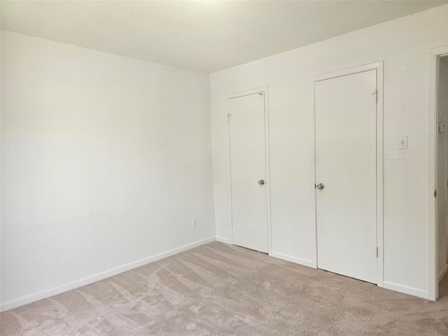 9201 Clarewood Dr Unit 204, Houston, TX 77036 - unfurnished bedroom featuring light carpet and baseboards