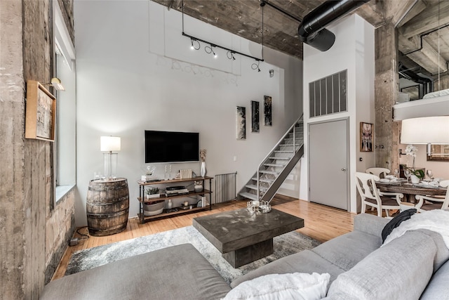 705 Main St Unit 801, Houston, TX 77002 - living area featuring a towering ceiling, wood finished floors, and stairway