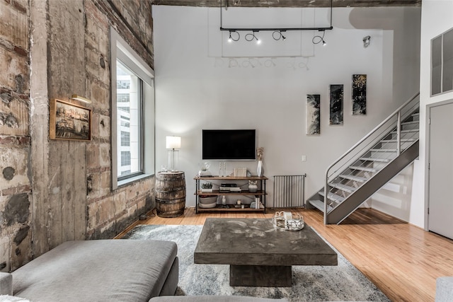 705 Main St Unit 801, Houston, TX 77002 - living room featuring stairway, wood finished floors, and healthy amount of natural light