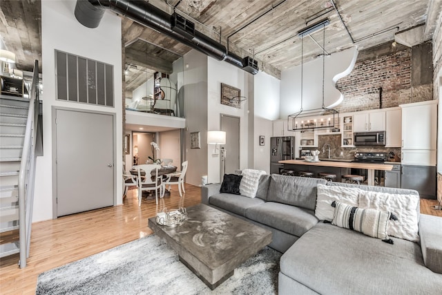 705 Main St Unit 801, Houston, TX 77002 - living room with a towering ceiling, light wood-style floors, and stairway