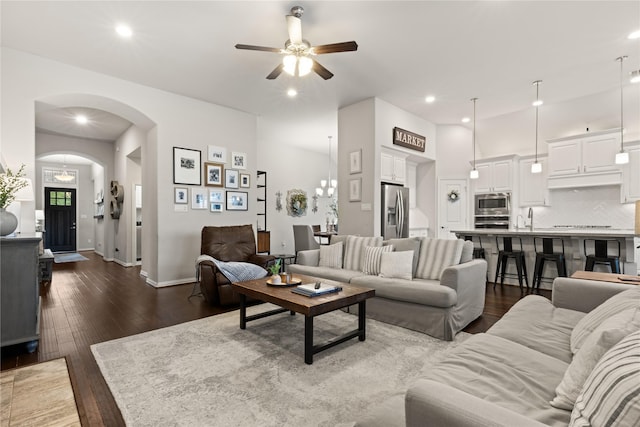 8903 Purdy Crescent Trl, Richmond, TX 77406 - living area with ceiling fan, dark wood-style flooring, arched walkways, and recessed lighting