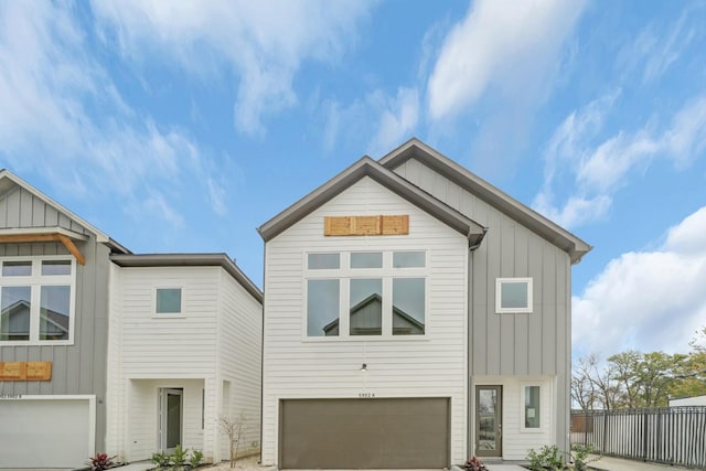 2504 W Tidwell Rd Unit C, Houston, TX 77091 - view of front of home with an attached garage, board and batten siding, and concrete driveway