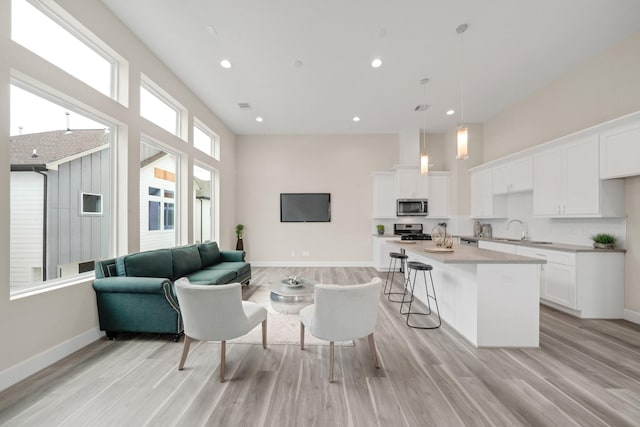 2504 W Tidwell Rd Unit C, Houston, TX 77091 - living room with light wood-style floors, recessed lighting, and a high ceiling