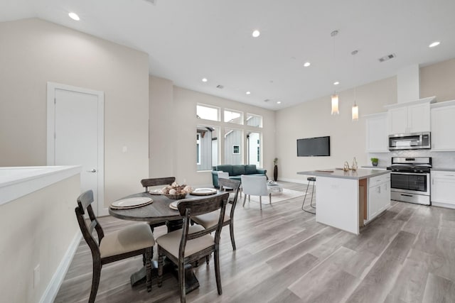 2504 W Tidwell Rd Unit C, Houston, TX 77091 - dining space featuring light wood-style floors, recessed lighting, and a high ceiling