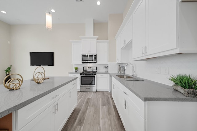 2504 W Tidwell Rd Unit C, Houston, TX 77091 - kitchen with appliances with stainless steel finishes, light stone countertops, white cabinetry, tasteful backsplash, and recessed lighting