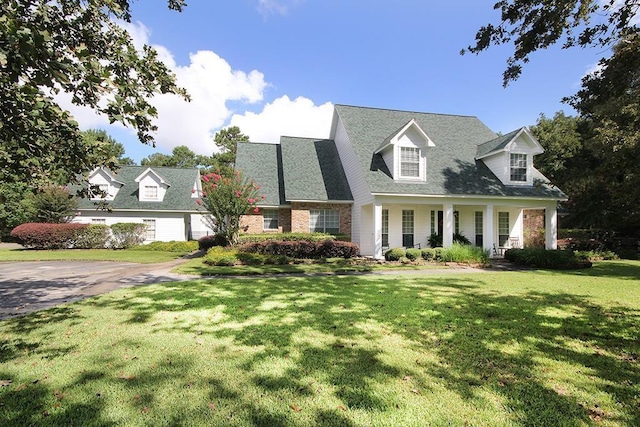 36218 Post Oak Cir, Magnolia, TX 77355 - new england style home with covered porch and a front lawn