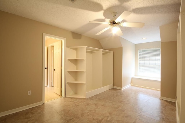 36218 Post Oak Cir, Magnolia, TX 77355 - unfurnished bedroom with a textured ceiling, lofted ceiling, and a ceiling fan