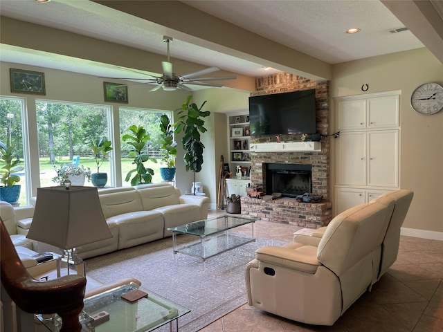 36218 Post Oak Cir, Magnolia, TX 77355 - tiled living room with ceiling fan, a brick fireplace, and recessed lighting