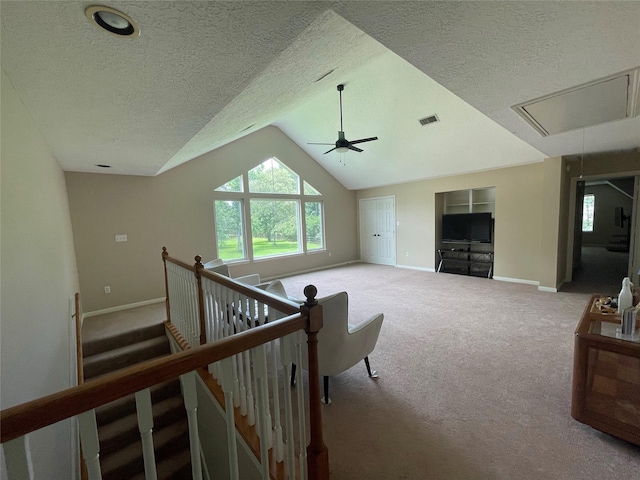 36218 Post Oak Cir, Magnolia, TX 77355 - carpeted living area featuring attic access, a textured ceiling, ceiling fan, and lofted ceiling