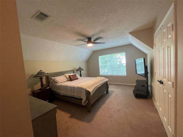 36218 Post Oak Cir, Magnolia, TX 77355 - carpeted bedroom with a textured ceiling, vaulted ceiling, a ceiling fan, and a closet