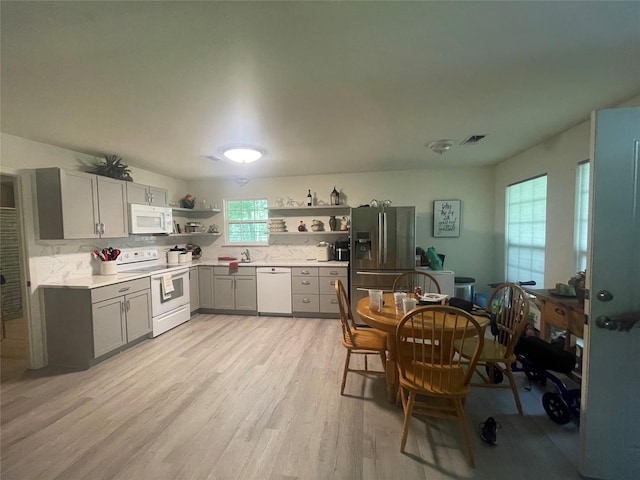 36218 Post Oak Cir, Magnolia, TX 77355 - kitchen featuring white appliances, open shelves, gray cabinets, light wood-style floors, and backsplash