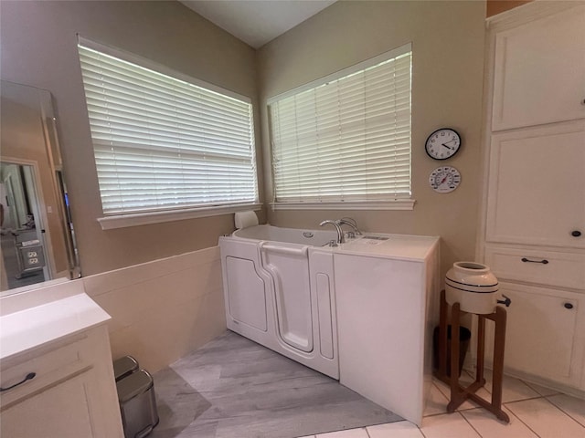 36218 Post Oak Cir, Magnolia, TX 77355 - full bath featuring a garden tub, vanity, and tile patterned floors