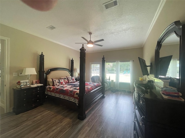 36218 Post Oak Cir, Magnolia, TX 77355 - bedroom featuring dark wood-style floors, a textured ceiling, crown molding, and a ceiling fan