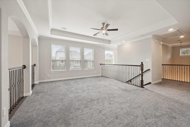13223 Parkway Spring Dr, Houston, TX 77077 - carpeted empty room featuring attic access, crown molding, a raised ceiling, a ceiling fan, and arched walkways
