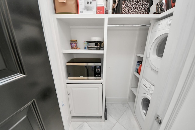 3711 Somerset Commons Ln, Houston, TX 77055 - laundry room with stacked washing machine and dryer and marble look tile flooring