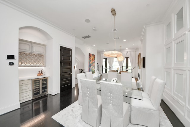 3711 Somerset Commons Ln, Houston, TX 77055 - dining area featuring wine cooler, a dry bar, ornamental molding, dark wood-style floors, and recessed lighting