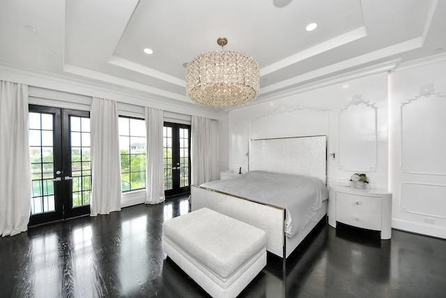 3711 Somerset Commons Ln, Houston, TX 77055 - bedroom with french doors, a tray ceiling, access to exterior, wood finished floors, and a chandelier