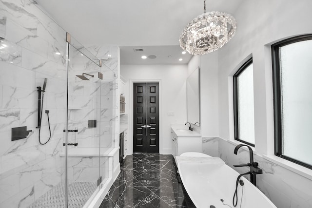 3711 Somerset Commons Ln, Houston, TX 77055 - bathroom with marble tiled floors, a soaking tub, a marble finish shower, vanity, and recessed lighting