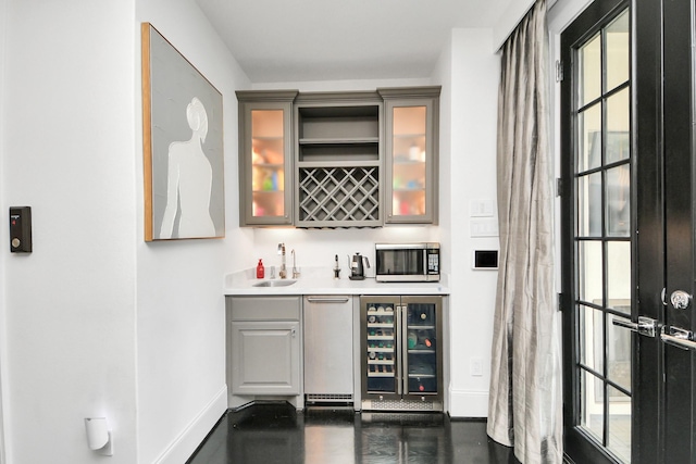 3711 Somerset Commons Ln, Houston, TX 77055 - indoor wet bar featuring stainless steel microwave, wine cooler, and plenty of natural light