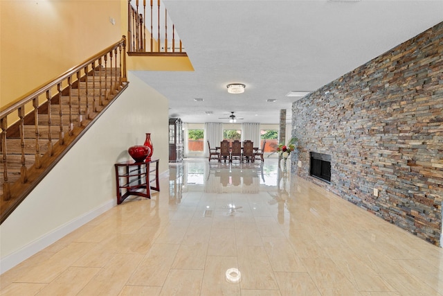 10422 Springland Ct, Houston, TX 77065 - living room featuring stairs, a ceiling fan, and a stone fireplace
