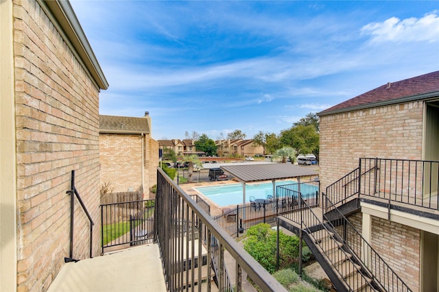 8100 Cambridge St Unit 114, Houston, TX 77054 - balcony featuring stairway and a residential view
