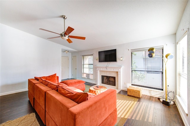 8100 Cambridge St Unit 114, Houston, TX 77054 - living area with wood finished floors, vaulted ceiling, a tiled fireplace, and ceiling fan