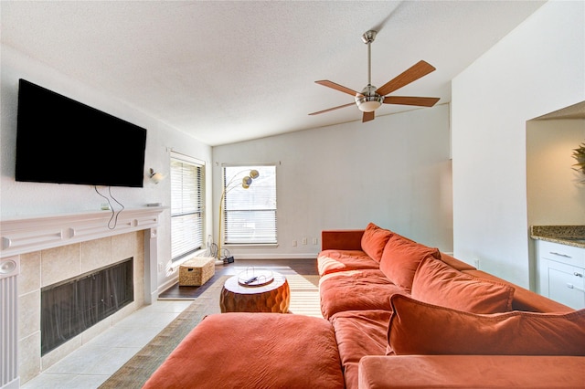 8100 Cambridge St Unit 114, Houston, TX 77054 - living room featuring lofted ceiling, a fireplace, a ceiling fan, and a textured ceiling