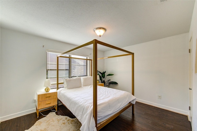 8100 Cambridge St Unit 114, Houston, TX 77054 - bedroom with baseboards and wood finished floors