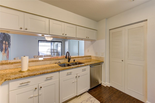 8100 Cambridge St Unit 114, Houston, TX 77054 - kitchen with stainless steel dishwasher, white cabinetry, light stone countertops, and dark wood-type flooring