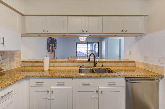8100 Cambridge St Unit 114, Houston, TX 77054 - kitchen with stainless steel dishwasher, white cabinets, decorative backsplash, and light stone counters