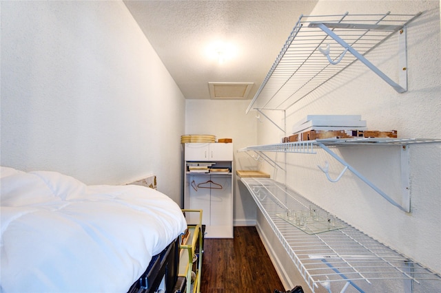 8100 Cambridge St Unit 114, Houston, TX 77054 - bedroom featuring dark wood-style flooring, attic access, and a textured wall