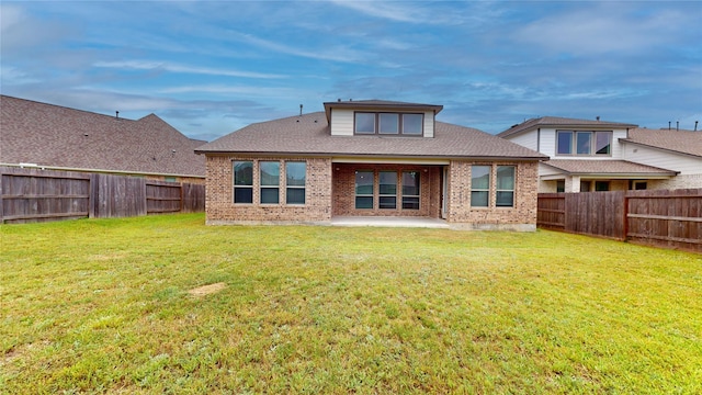 23604 Olive Creek Ln, New Caney, TX 77357 - back of property featuring brick siding, a fenced backyard, and a patio