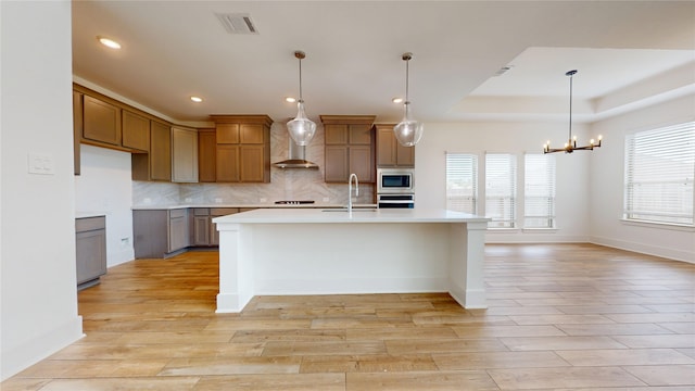 23604 Olive Creek Ln, New Caney, TX 77357 - kitchen with appliances with stainless steel finishes, light countertops, backsplash, light wood finished floors, and recessed lighting