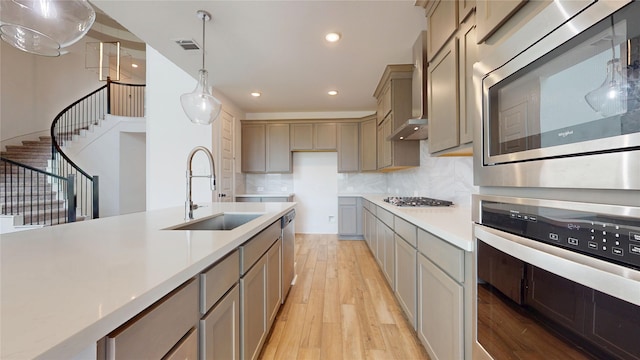 23604 Olive Creek Ln, New Caney, TX 77357 - kitchen with stainless steel appliances, light wood-type flooring, recessed lighting, light countertops, and decorative backsplash