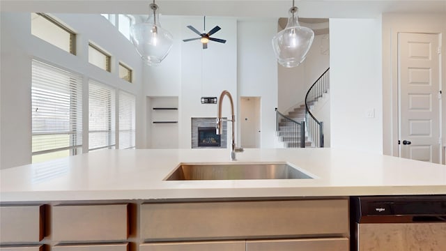 23604 Olive Creek Ln, New Caney, TX 77357 - kitchen featuring dishwasher, open floor plan, a ceiling fan, light countertops, and a high ceiling