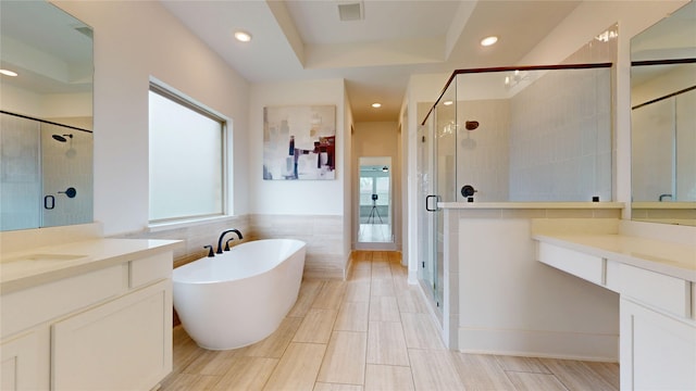 23604 Olive Creek Ln, New Caney, TX 77357 - full bath with a shower stall, vanity, a soaking tub, tile walls, and recessed lighting