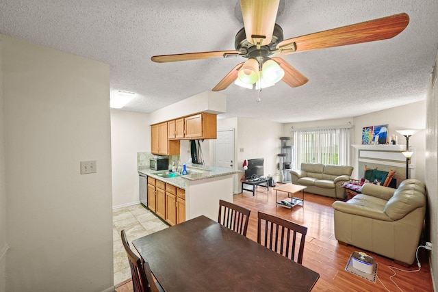 2120 El Paseo St Unit 1403, Houston, TX 77054 - dining area featuring ceiling fan, a textured ceiling, and light wood-style floors