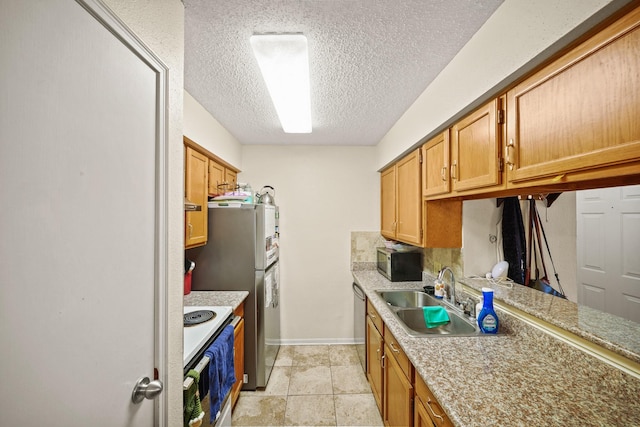 2120 El Paseo St Unit 1403, Houston, TX 77054 - kitchen with stainless steel appliances, a textured ceiling, and light countertops