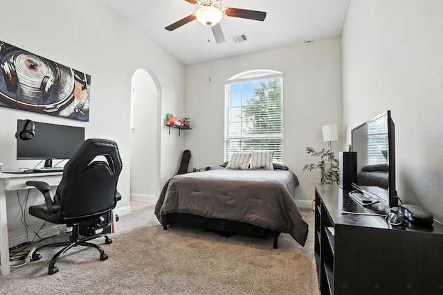 15415 Wildpoint Dr, Cypress, TX 77429 - bedroom featuring arched walkways, carpet floors, a desk, and a ceiling fan