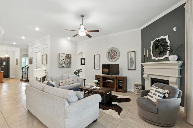 15415 Wildpoint Dr, Cypress, TX 77429 - living room featuring arched walkways, light tile patterned floors, crown molding, a fireplace, and a ceiling fan