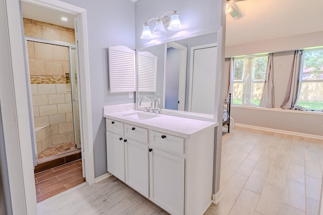 4218 E Terrace Creek Cir, Houston, TX 77014 - bathroom featuring a shower stall, vanity, and wood tiled floors
