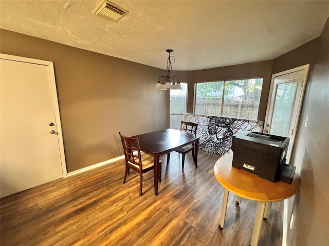2702 Dovewood Ln, Spring, TX 77373 - dining space featuring dark wood-type flooring, a chandelier, and a textured ceiling