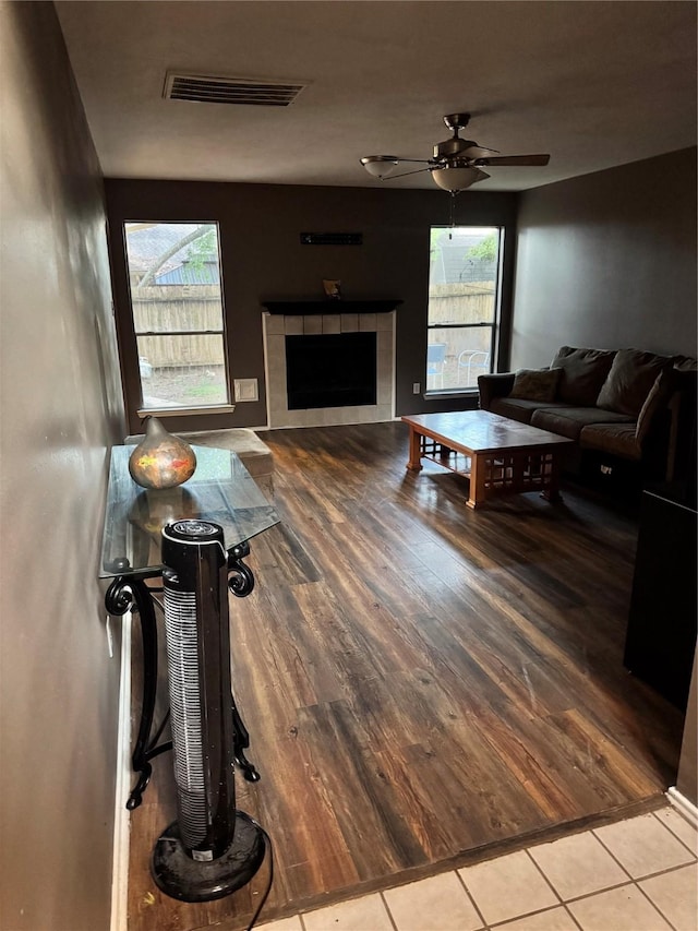 2702 Dovewood Ln, Spring, TX 77373 - living area with wood finished floors, ceiling fan, and a tiled fireplace