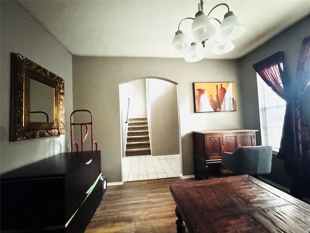 2702 Dovewood Ln, Spring, TX 77373 - dining space with arched walkways, a chandelier, dark wood-style floors, and stairway