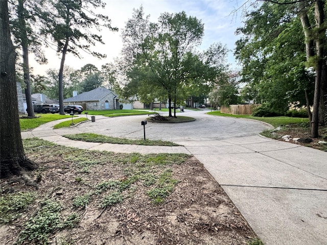 2702 Dovewood Ln, Spring, TX 77373 - view of home's community featuring curved driveway and a lawn